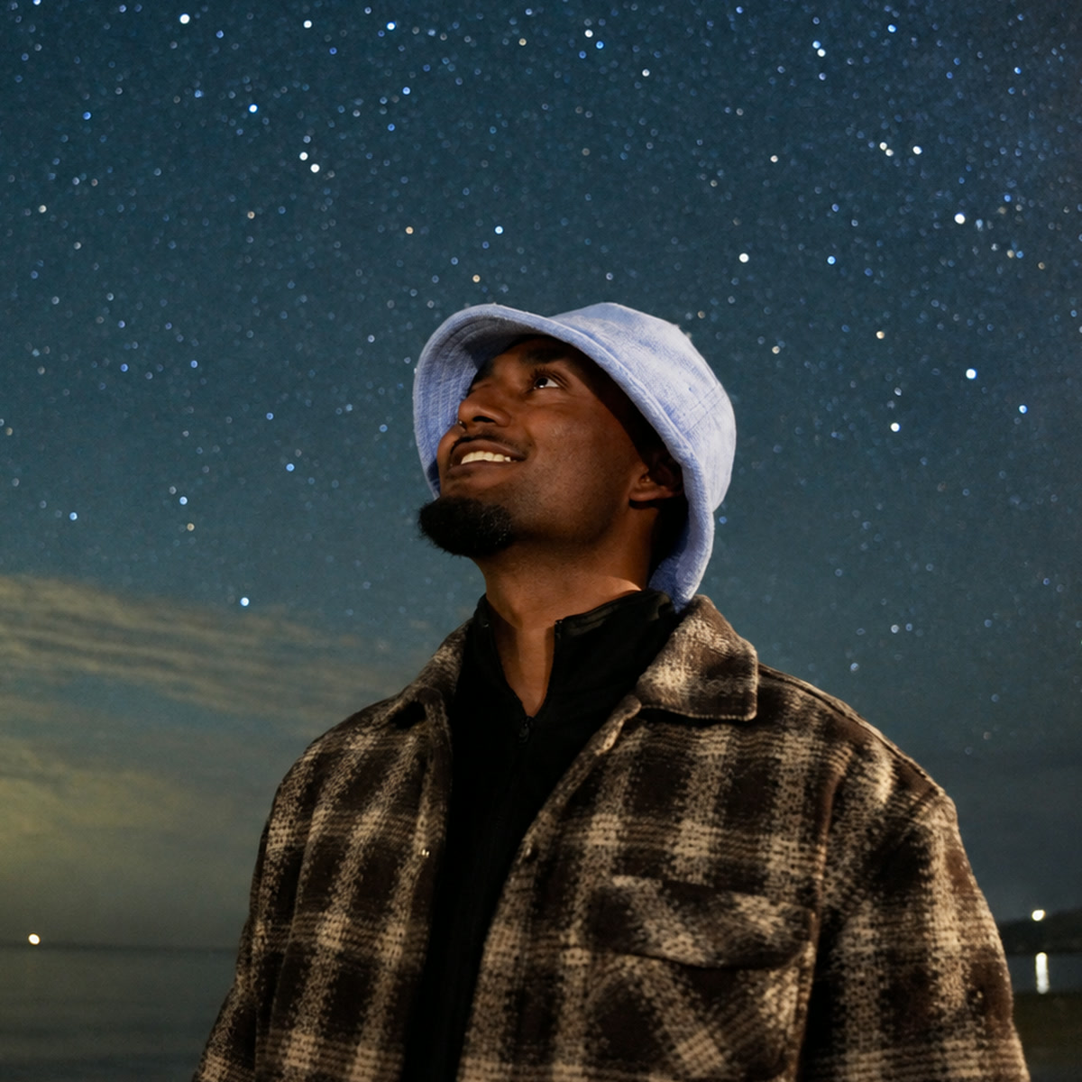 Ryan Lal looking into a star-filled night sky