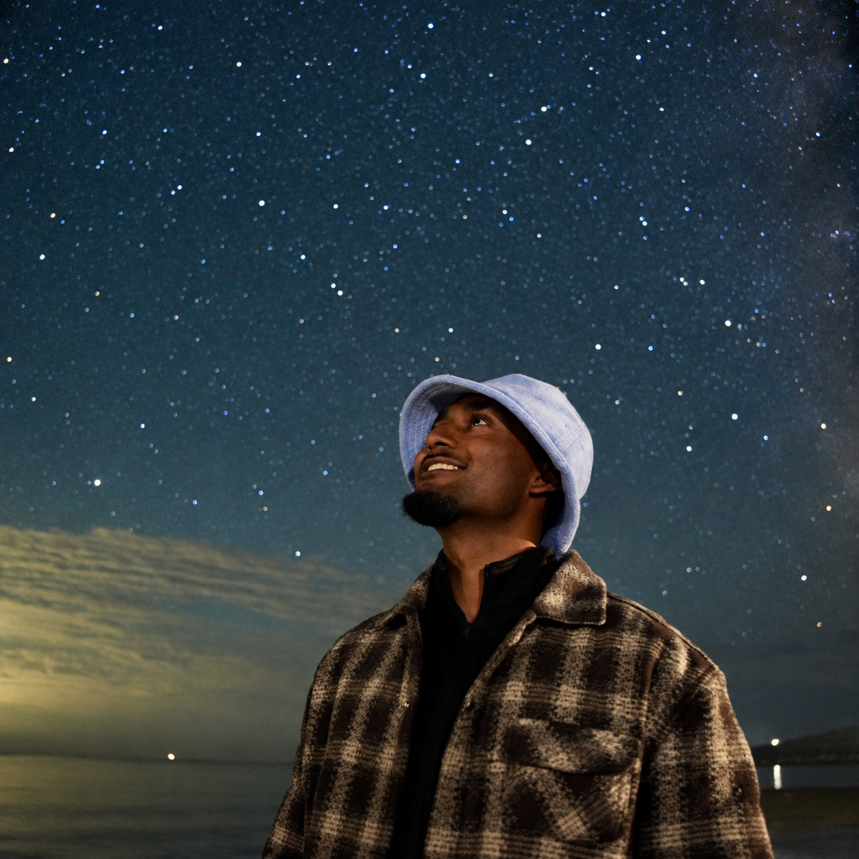 Ryan Lal looking into a star-filled night sky